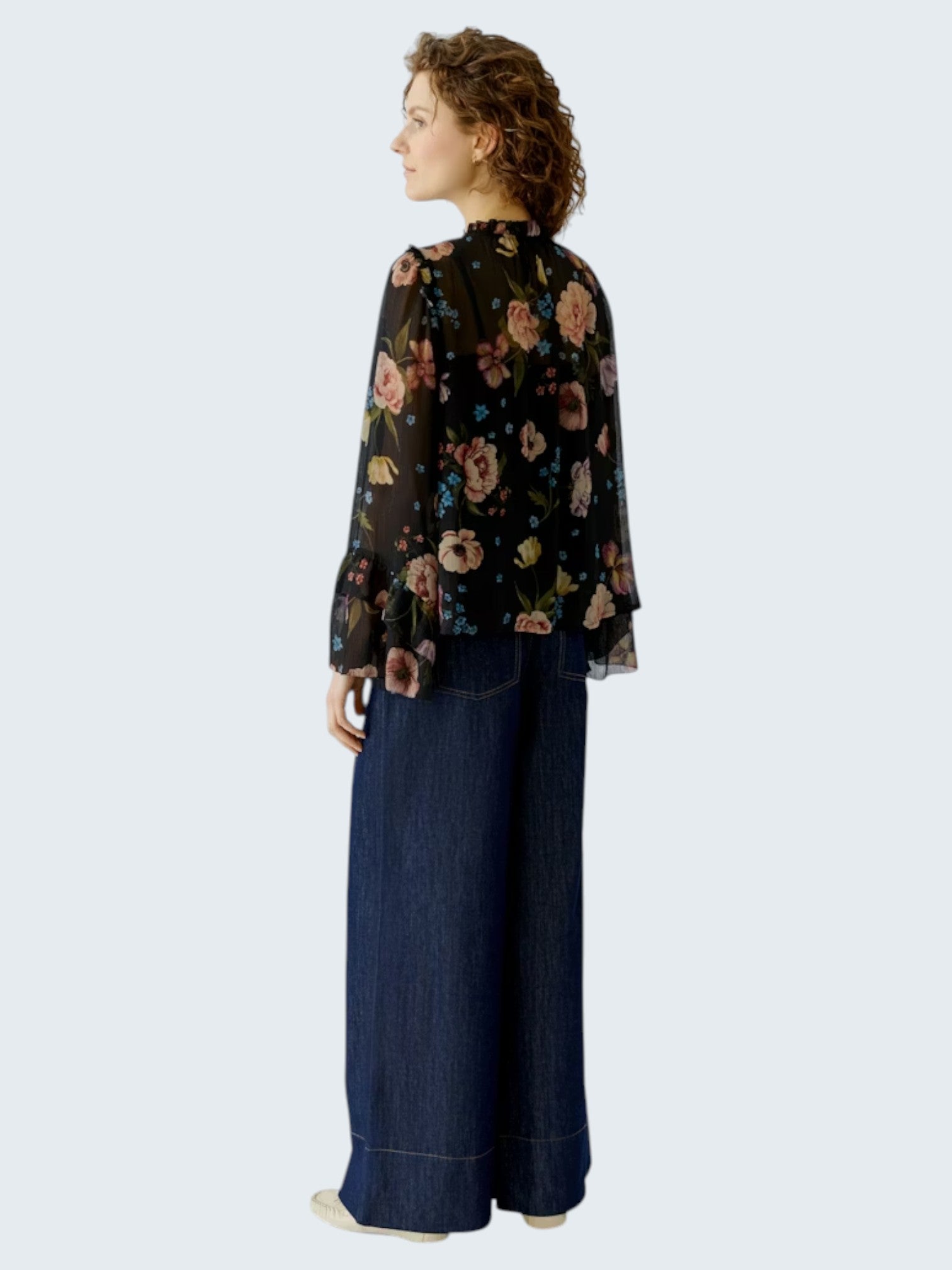 oui-ua.store black chiffon boho blouse with floral print, ruffles, and wide bell sleeves.